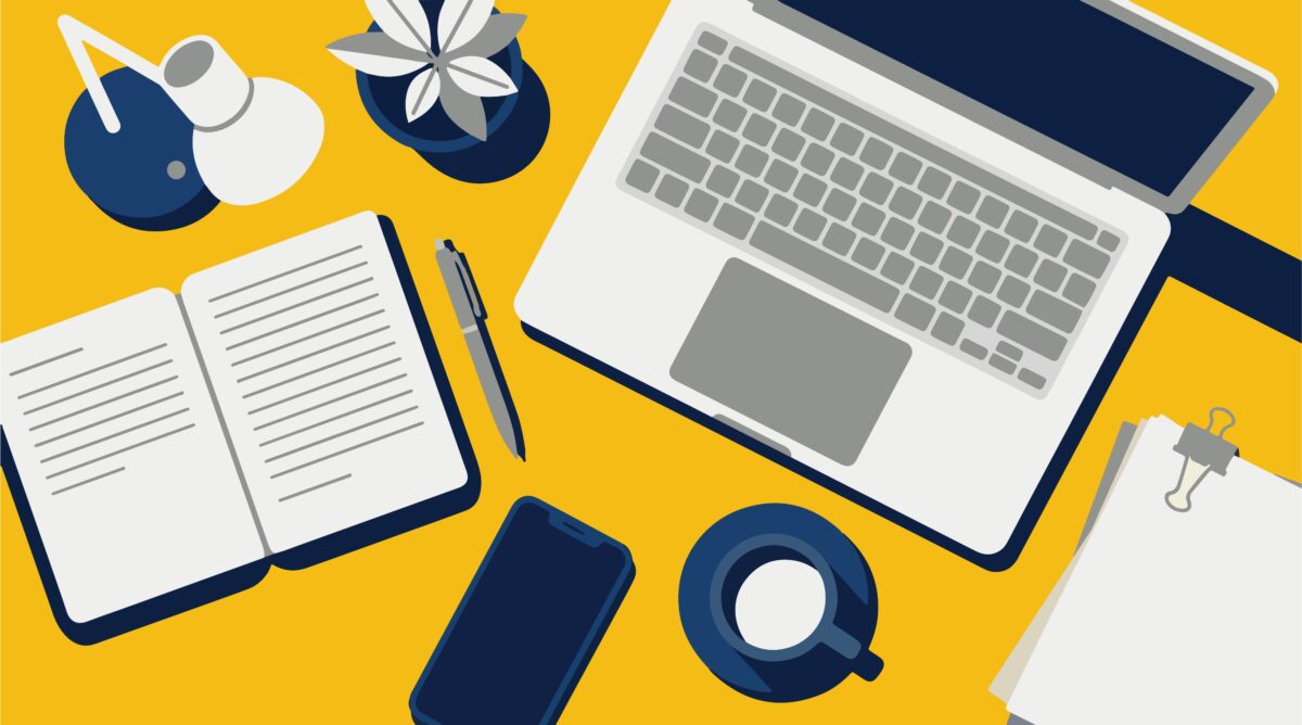 Grafik eines Schreibtisch mit Laptop, Notizbuch, Kaffeetasse und anderen Utensilien